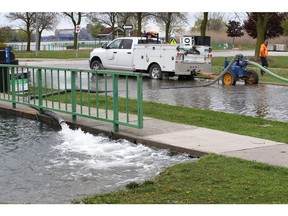 Windsor, Ontario. May 19, 2020. Town of LaSalle staff kept a heavy duty pump running to reduce water levels on Laurier Drive at LaSalle Marina Tuesday.