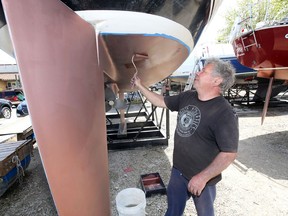 Skipper Lorne Seeger applies VC 17, an anti-fouling bottom paint to the hull of his sailing vessel at South Port Sailing Club Wednesday. Conditions to apply paint couldn't have been better for Seeger, with temperatures climbing toward 20C.
