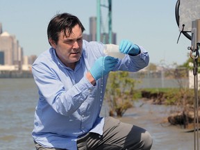 Windsor, Ontario. May 20, 2020.  Mike McKay, executive director at Great Lakes Institute for Environmental Research, examines an effluant water sample from the Detroit River Wednesday.  McKay and his University of Windsor team are   studying sewage wastes to monitor COVID-19.  See story.
