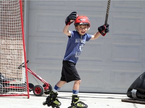 He shot! He scored! Aidan Samrah, 7, celebrates a goal against his brother Evan, 10, while playing hockey on his driveway in Riverside on Friday, May 1, 2020.