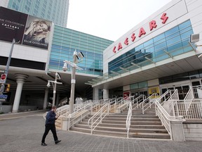 Windsor, Ontario. May 5, 2020.  A lone pedestrian walks along the Chatham Street sidewalk in front of Caesars Windsor Tuesday.  See story.