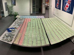Seven hundred grams of cannabis and cannabis by-products, and $14,070 in Canadian currency seized from a vehicle in LaSalle is seen inside LaSalle police headquarters in this photo from the LaSalle Police Service on Friday, May 15, 2020.