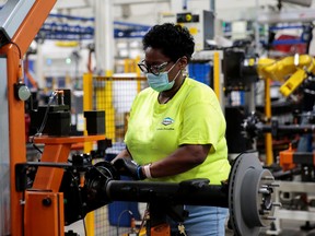 An auto industry worker assembles a vehicle part at a plant in Toledo, Ohio.