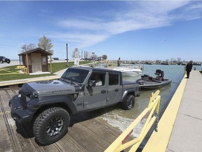 WINDSOR, ON. MAY 13, 2020 -  Rick Parent of Windsor launches his boat with the help of friend Eve Martinico at the Belle River Marina on Wednesday, May 13, 2020, shortly after noon when the ramp officially opened for the first time in weeks due to the pandemic.