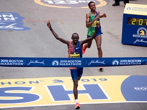 In this file photo Kenyan Lawrence Cherono edges Ethopian Lelisa Desisa for first place for the Men's Elite race, at the 123rd Boston Marathon on April 15, 2019 in Boston, Mass.