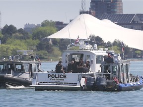 Marine units from the RCMP, left. OPP, centre, and Windsor Police are shown on the Detroit River near downtown Windsor, ON. on Tuesday, May 26 conducting a search for a person who jumped in the river near Riverside and Ouellette over the weekend.