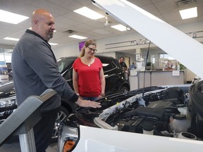 Janis Robert looks over a 2020 GMC Terrain with Claudio Gesuale a salesman at Gus Revenberg Chevrolet Buick GM in Windsor, ON. on Thursday, May 28, 2020. Robert, a frontline health care worker in the city purchased a similar model.