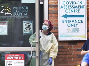 While COVID-19 cases are all the news, hospitals are reminding the public that their emergency departments are open for all medical emergencies. Here, a health-care worker is shown at the Windsor Regional Hospital Ouellette campus COVID-19 assessment centre on May 25, 2020.