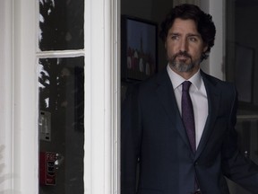 Prime Minister Justin Trudeau looks towards the podium as he walks out the front door of Rideau Cottage to attend a news conference in Ottawa, Monday, May 25, 2020.