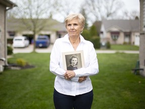 Barb Rideout holds a portrait of her late mother, Connie Broyd, who passed away from COVID-19, Thursday, April 30, 2020.
