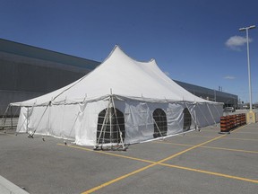 Getting ready for the restart. Ahead of the resumption of production at FCA Canada's Windsor Assembly Plant, tents to test workers for COVID-19 were being set up in the employee parking lots on Friday, May 1, 2020.