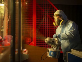 Co-owner, Beau Dubois, uses a disinfectant fogging machine to disinfect Super Bowl bowling alley,  Wednesday, May 27, 2020.