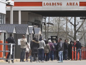 Customers line up to enter the Home Depot in east Windsor on Sunday, May 10, 2020. It was the first weekend since the lockdown began that hardware stores were permitted to have in store sales.