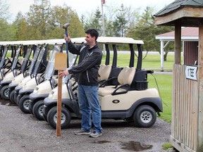 Josh Malott, general manager of Belleview Golf Club in Woodslee, puts up a physical distancing sign on May 15, 2020. Golf courses in Ontario have been permitted to re-open on May 16.