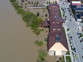 Rising flood waters of the Tittabawassee River advance upon the city after the breach of two dams, Edenville and Sanford, in Midland, Michigan, Wednesday, May 20, 2020.