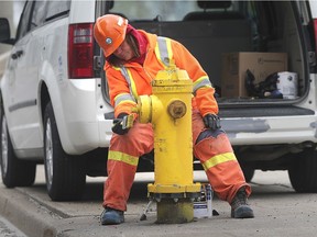 WINDSOR, ON. MAY 8, 2020 -  Kim Delisle, an employee with ENWIN Utilities puts a fresh coat of paint on a fire hydrant on Friday, May 8, 2020 on Riverside Dr. near Ouellette Ave.