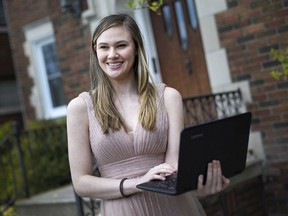 Mira Gillis, 18, a grade 12 student and Prime Minister at F. J. Brennan Catholic High School, wears her prom dress outside her home, Wednesday, May 7, 2020.  Gillis is organizing a virtual prom.