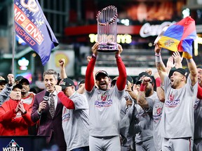 Manager Dave Martinez of the Washington Nationals hoists the Commissioners Trophy after defeating the Houston Astros 6-2 in Game 7 to win the 2019 World Series at Minute Maid Park on Oct. 30, 2019 in Houston, Texas.