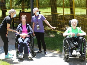 Hotel-Dieu Grace Healthcare patients Marion and Linton Herron are assisted by healthcare staff during their 63rd wedding anniversary Monday.  The Windsor couple had to stay two metres apart while visiting with their daughter Kym Herron Scott and son-in-law, Wayne Scott.