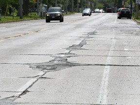 Pavement has been falling apart for years along University Avenue West.  In photo, scarred pavement of University Ave. West at Askin Avenue.