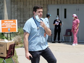 Dr. Ross Moncur, interim CEO of Erie Shores HealthCare, and staff prepare for the next group of migrant farm workers at the COVID-19 assessment centre at Leamington Kinsmen Recreation Centre on Wednesday, June 10, 2020.