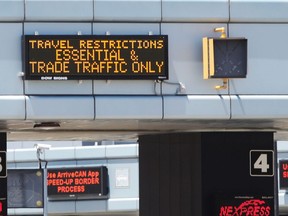 Windsor, Ontario. June 16, 2020. Windsor, Ontario entrance to the International border crossing at Detroit Windsor Tunnel Tuesday. The border between Canada and the U.S. will remain open for only essential workers and trade traffic. In photo, a small sign posts the travel restrictions above an empty booth.