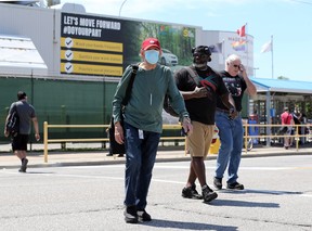 Day shift workers depart as afternoon shift employees arrive at FCA's Windsor Assembly Plant on Chrysler Centre Thursday.