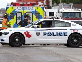 Windsor Police officers speak with Windsor firefighters while investigating a two-vehicle collision on Huron Church Road Tuesday. The idea of a regional police force is being floated by some local politicians.
