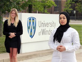 Zaynab Almousawi, right, head of the University of Windsor's criminology group, and Meighan Coulter keep physical distance as they discuss the launch of a GoFundMe page to help the Detroit Bail Out Project, to assist people arrested during Black Lives Matter rallies in the Motor City.