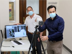 Fast temperature check. Fonda Asprakis, right, and business partner Dave Fortin, of Windsor tech firm DataRealm, are shown June 12, 2020, demonstrating a body temperature monitoring camera which can measure the temperatures of individuals in large crowds simultaneously to help in the fight against COVID-19.