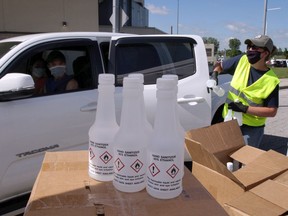 City of Windsor and Laser Transport staff hand out free bottles of hand sanitizer at the WFCU Centre on June 12, 2020.