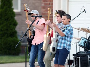 John Dorman, 14, left, Timothy Hole, 16, and Alex Bonadonna, 13, of Leave Those Kids Alone rock band perform a driveway concert for their neighbours in East Riverside June 13, 2020. The local kids rock band will be performing O Canada on Canada Day.