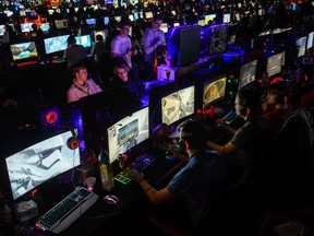 Participants sit at computer monitors to play video games at the 2018 DreamHack video gaming festival on January 27, 2018 in Leipzig, Germany. The three-day event brings together gaming enthusiasts mainly from German-speaking countries for events including eSports tournaments, cosplay contests and a LAN party with 1,500 participants.