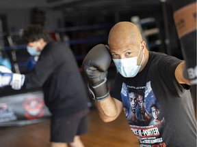 Josh Canty (right) and Renaldo Agostino (left) wear masks and demonstrate physical distancing at Windsor's Border City Boxing Club on June 3, 2020. The gym is tentatively (and legally) re-opening on June 5.