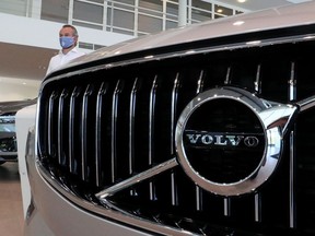 An employee at a Volvo car dealer, wearing a protective mask is seen in the showroom, amid the coronavirus disease (COVID-19) outbreak in Brussels, Belgium May 28, 2020.