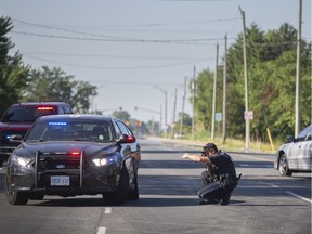 An OPP officer takes photos of two vehicles, including an OPP cruiser, involved in a motor vehicle collision on Walker Road, south of Highway 3, on Friday, June 19, 2020.