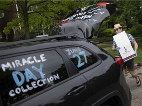 David Burrows volunteers on Kildare Road helping collect non-perishable goods for the Unemployed Help Centre's Miracle Food Drive, Saturday, June 27, 2020.