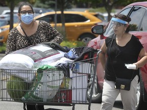WINDSOR, ON. JUNE 22, 2020 -  Shoppers wearing protective masks exit the Costco store in Windsor, ON. on Monday, June 22, 2020.