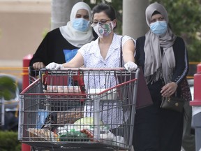 Shoppers wearing protective masks exit the Costco store in Windsor on Monday, June 22, 2020.