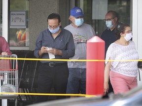 Shoppers wearing protective masks exit the Costco store in Windsor on Monday, June 22, 2020.