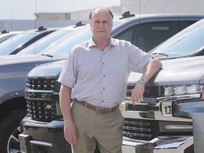 Mickey Pierre, a salesman at Gus Revenberg Chevrolet Buick GMC in Windsor, ON. is shown on Friday, June 19, 2020, with new Chevrolet pickups which have been a hot seller recently.