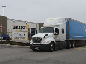 In this file photo taken on March 30, 2020 a truck is seen outside the Amazon warehouse in Staten Island as workers strike in demand that the facility be shut down and cleaned after one staffer tested positive for the coronavirus in New York.