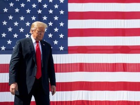 In this file photo taken on June 25, 2020 US President Donald Trump gestures following a tour of Fincantieri Marinette Marine in Marinette, Wisconsin.