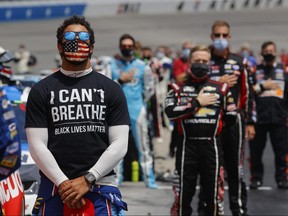 Bubba Wallace wears a "I Can't Breath - Black Lives Matter" T-shirt under his fire suit prior to the NASCAR Cup Series Folds of Honor QuikTrip 500 at Atlanta Motor Speedway on June 7, 2020 in Hampton, Georgia.