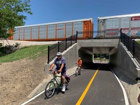 Cyclists make use of the new underpass where Dougall Avenue meets the CN Rail tracks in Windsor's south end on June 16, 2020.