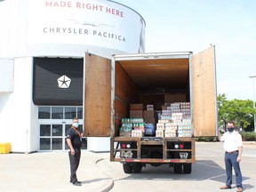 FCA Canada representatives stand by a truck loaded with food donations meant for the June 27 Miracle food drive in Windsor Essex.