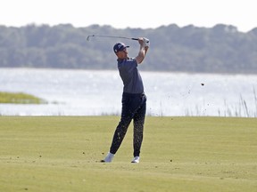 Webb Simpson hits his second shot on the 18th hole during the first round of the RBC Heritage golf tournament at Harbour Town Golf Links.