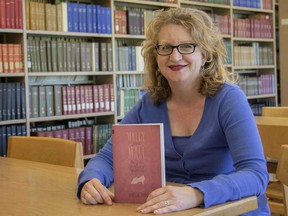 Windsor humour writer and University of Windsor librarian Heidi Jacobs with her debut novel, Molly of the Mall: Literary Lass and Purveyor of Fine Footwear.