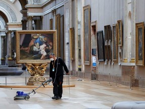 A worker polishes the floor in a gallery at the Louvre museum in Paris as it prepares to reopen its doors to the public in France, June 23, 2020.