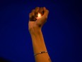 A woman holds an electric candle in her hand at a rally against racial inequality and the police shooting death of Rayshard Brooks, in Atlanta, Georgia, U.S. June 17, 2020.